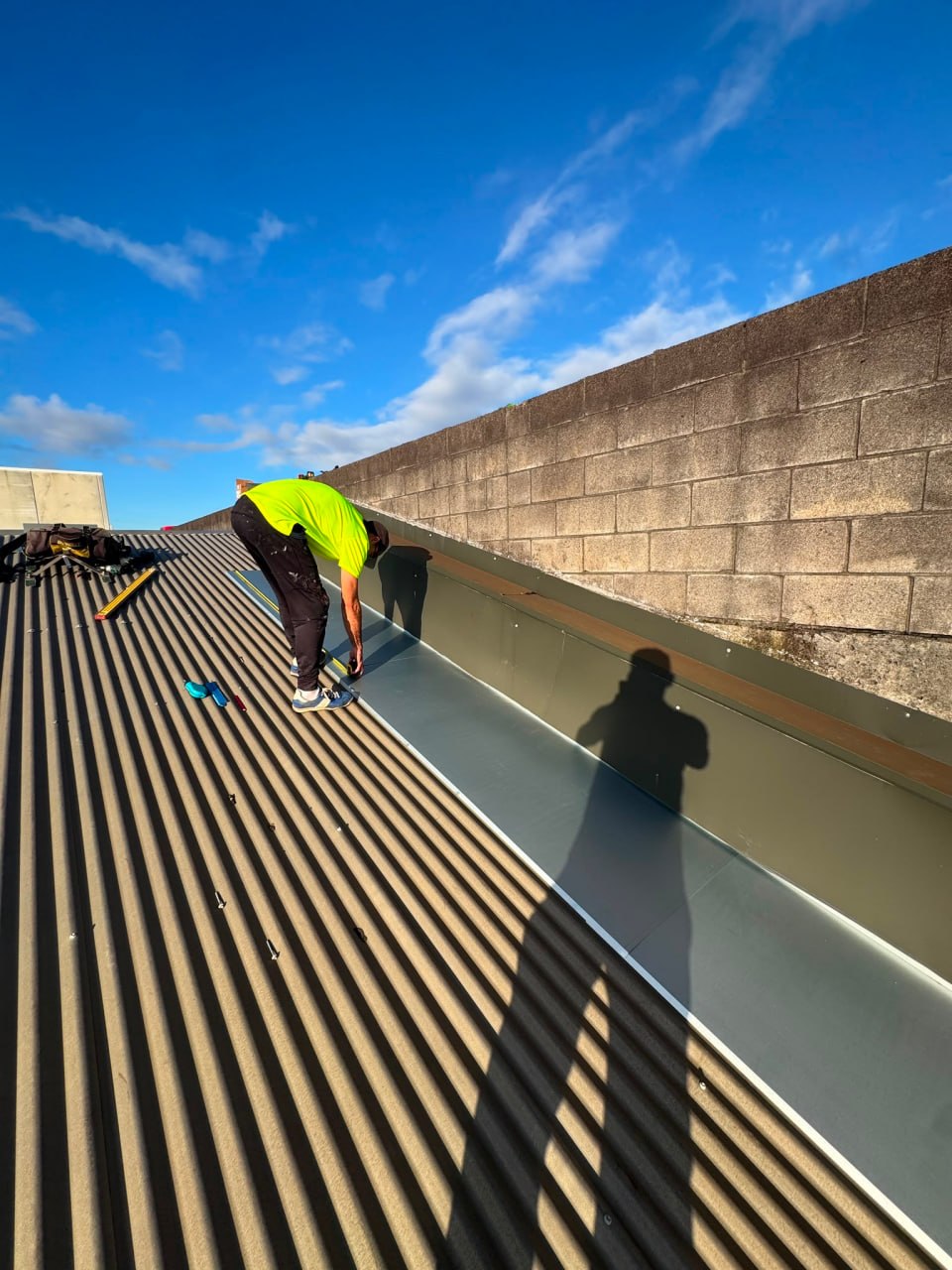 Technician sealing membrane seams on flat roof