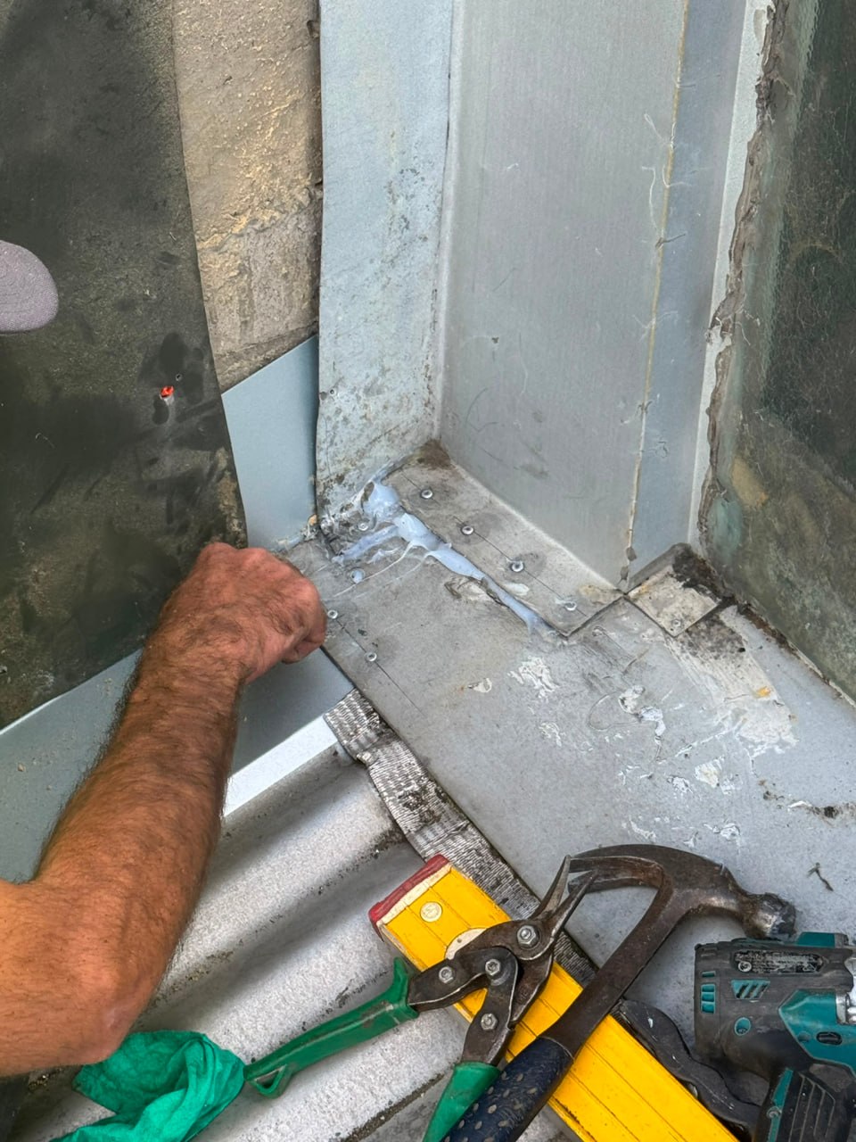 Flashing and membrane detail work at roof junction