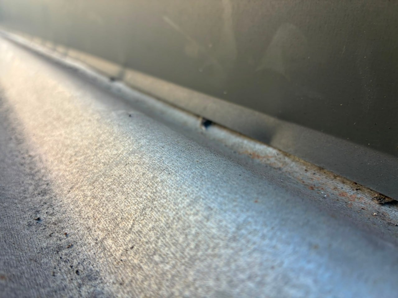 Missing fastener and surface corrosion on metal roof panel
