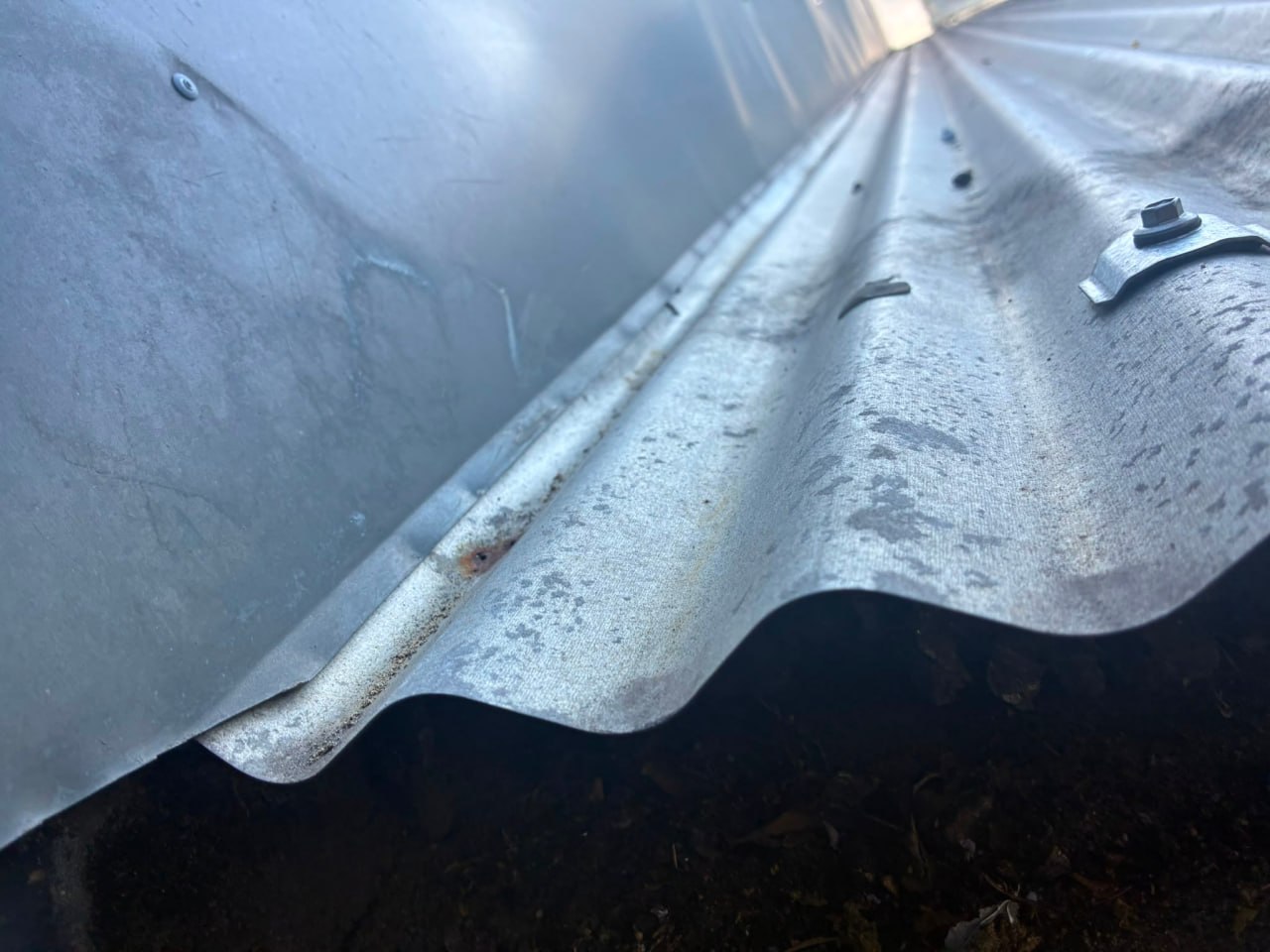 Rust and sealant failure at roof eave junction